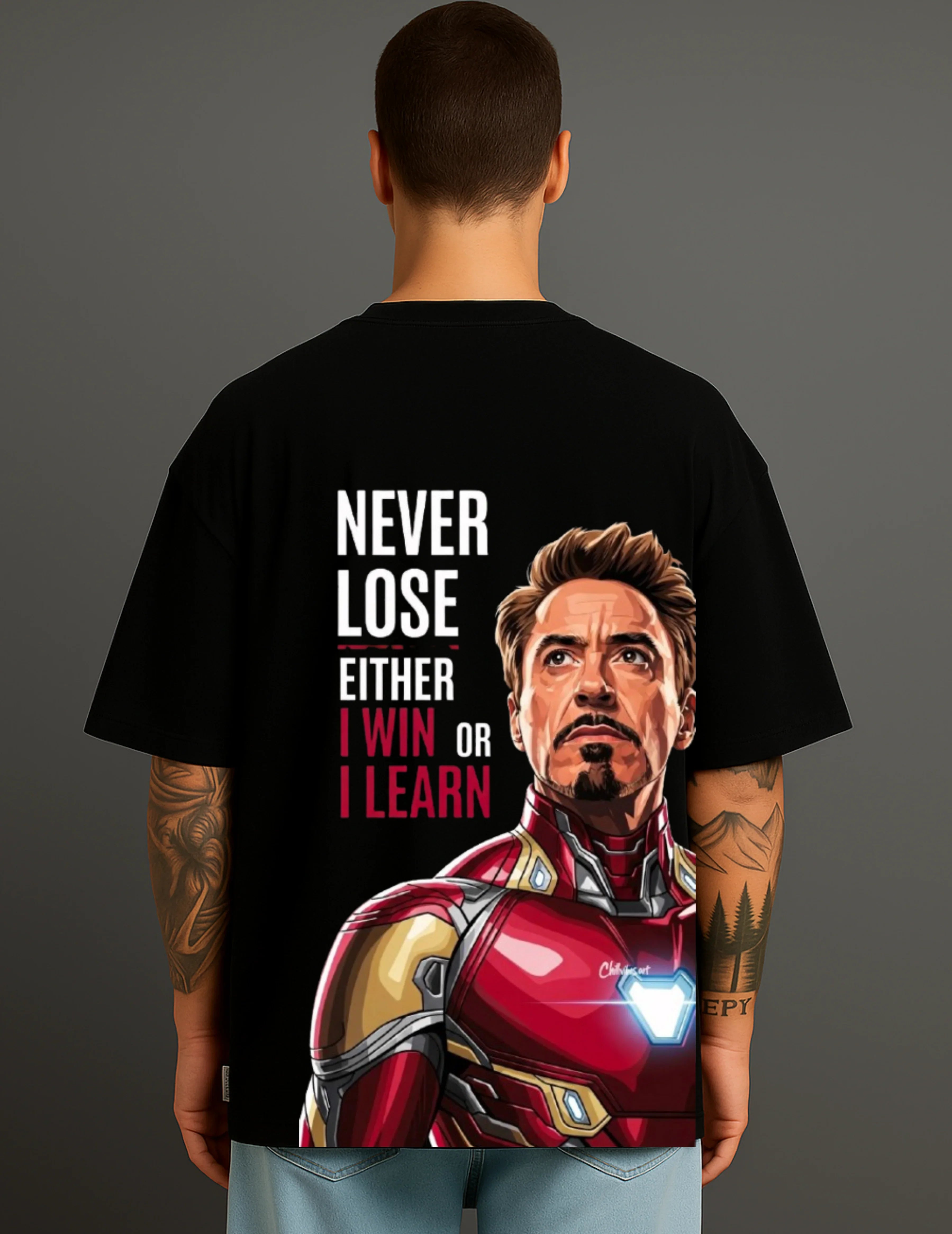 Man wearing black ATRAYE streetwear T-shirt with Iron Man graphic and inspirational quote