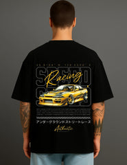 Man wearing black oversized ATRAYE streetwear T-shirt featuring yellow sports car and Speed Racing graphic.