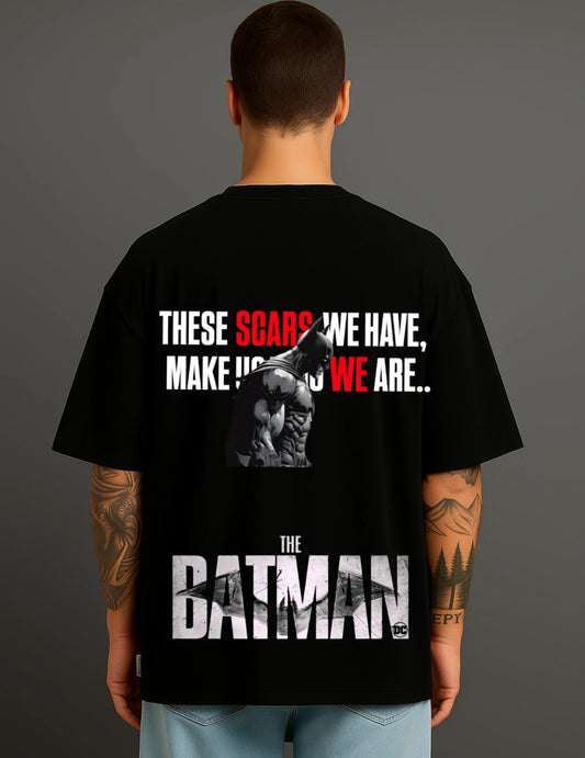 Back view of man wearing ATRAYE black Batman T-shirt with bold graphic and motivational quote