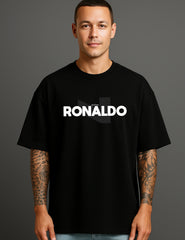 Man wearing a black ATRAYE streetwear T-shirt with bold 'RONALDO' print, tattooed arms visible.