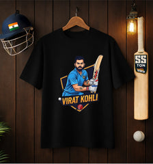 Black ATRAYE T-shirt with Virat Kohli cricket graphic, displayed with helmet and bat on wooden wall