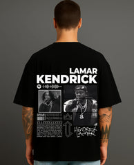 Man wearing black ATRAYE streetwear T-shirt with bold 'Lamar Kendrick' graphic and artist photos.