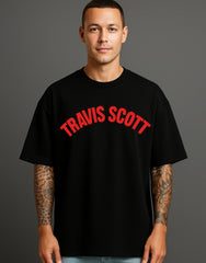Man wearing black streetwear T-shirt with bold red 'TRAVIS SCOTT' print, ATRAYE style