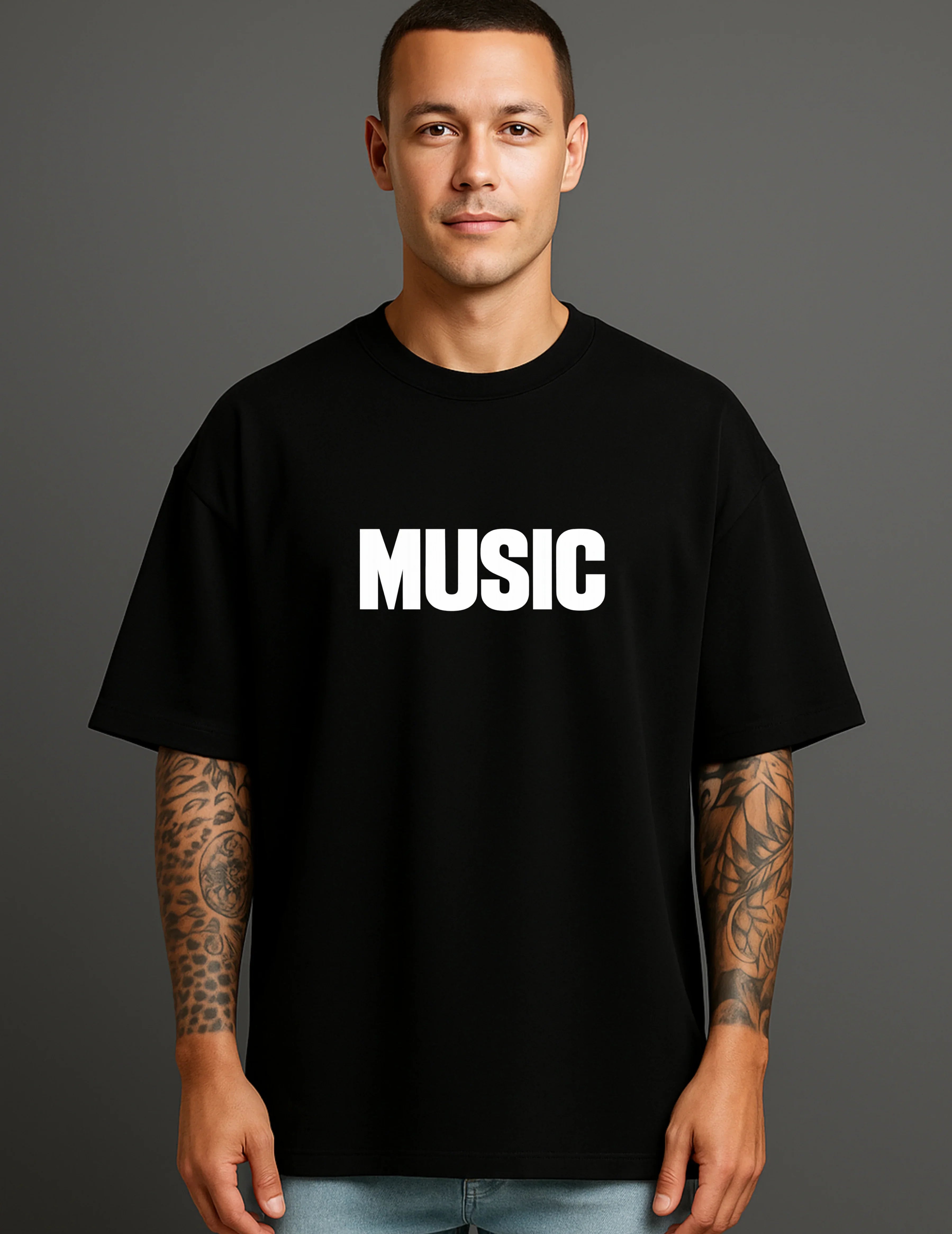 Man wearing ATRAYE black streetwear T-shirt with bold 'MUSIC' print, celebrating individuality.