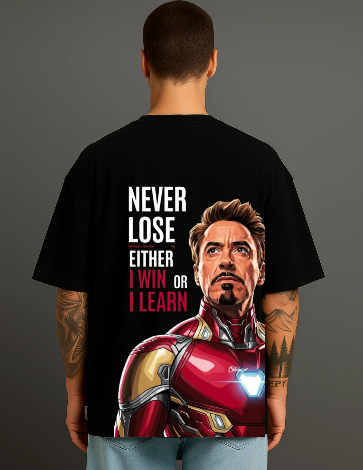 Man wearing black ATRAYE streetwear T-shirt with Iron Man graphic and inspirational quote
