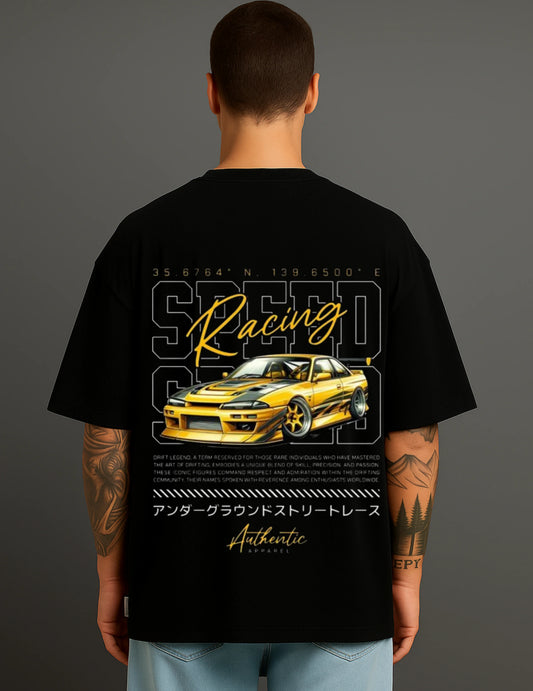 Man wearing black oversized ATRAYE streetwear T-shirt featuring yellow sports car and Speed Racing graphic.