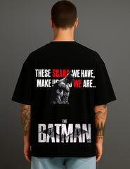 Back view of man wearing ATRAYE black Batman T-shirt with bold graphic and motivational quote
