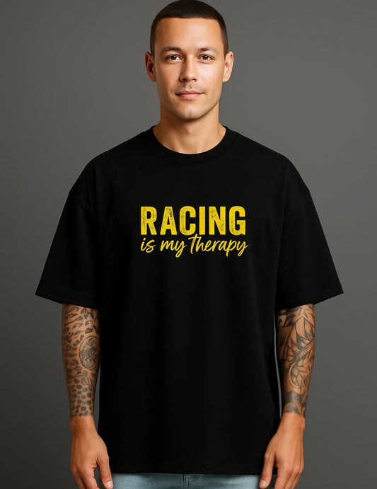 Man wearing a black ATRAYE streetwear T-shirt with yellow 'Racing is my therapy' print.
