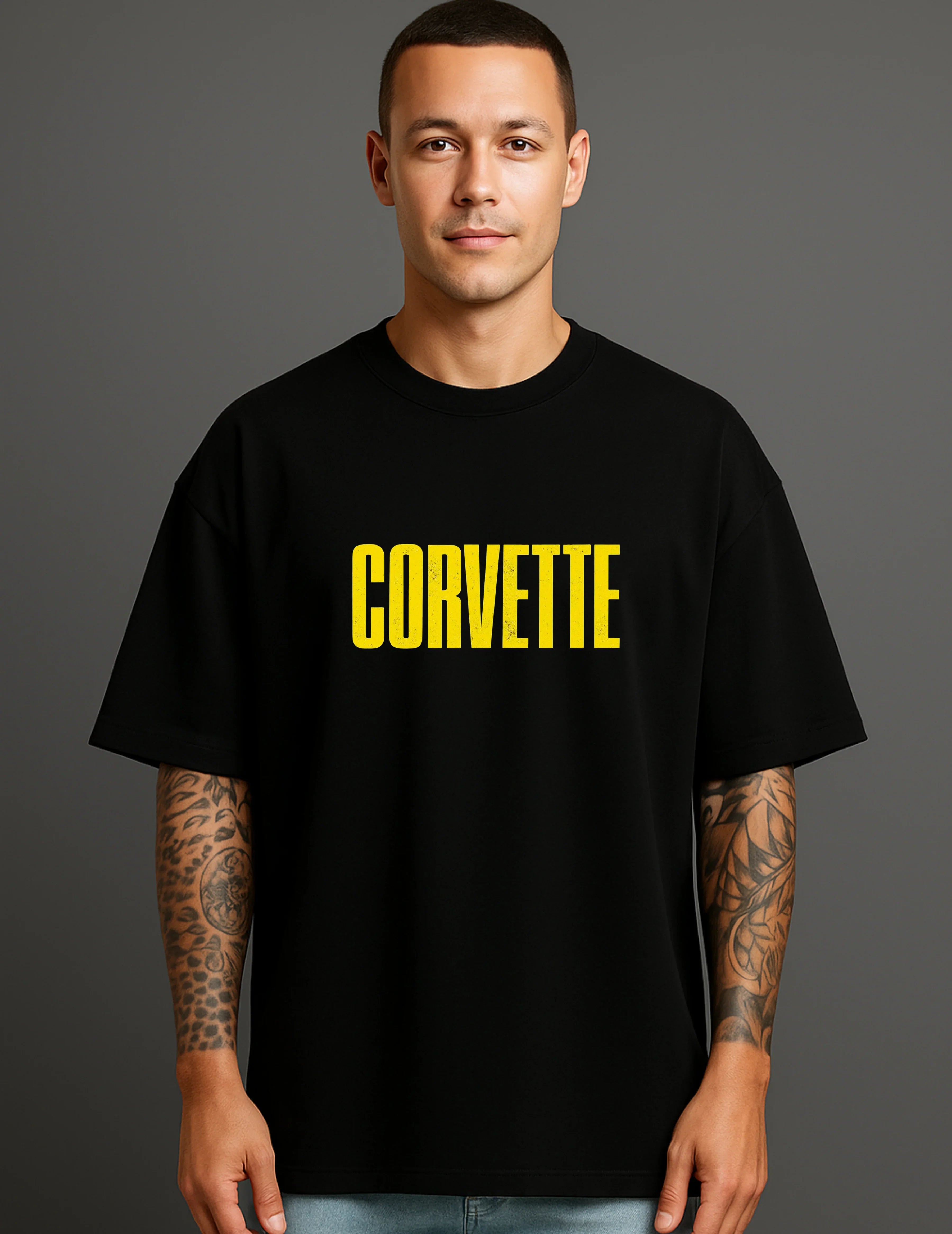 Man in black ATRAYE streetwear T-shirt with bold yellow 'CORVETTE' print, casual style.