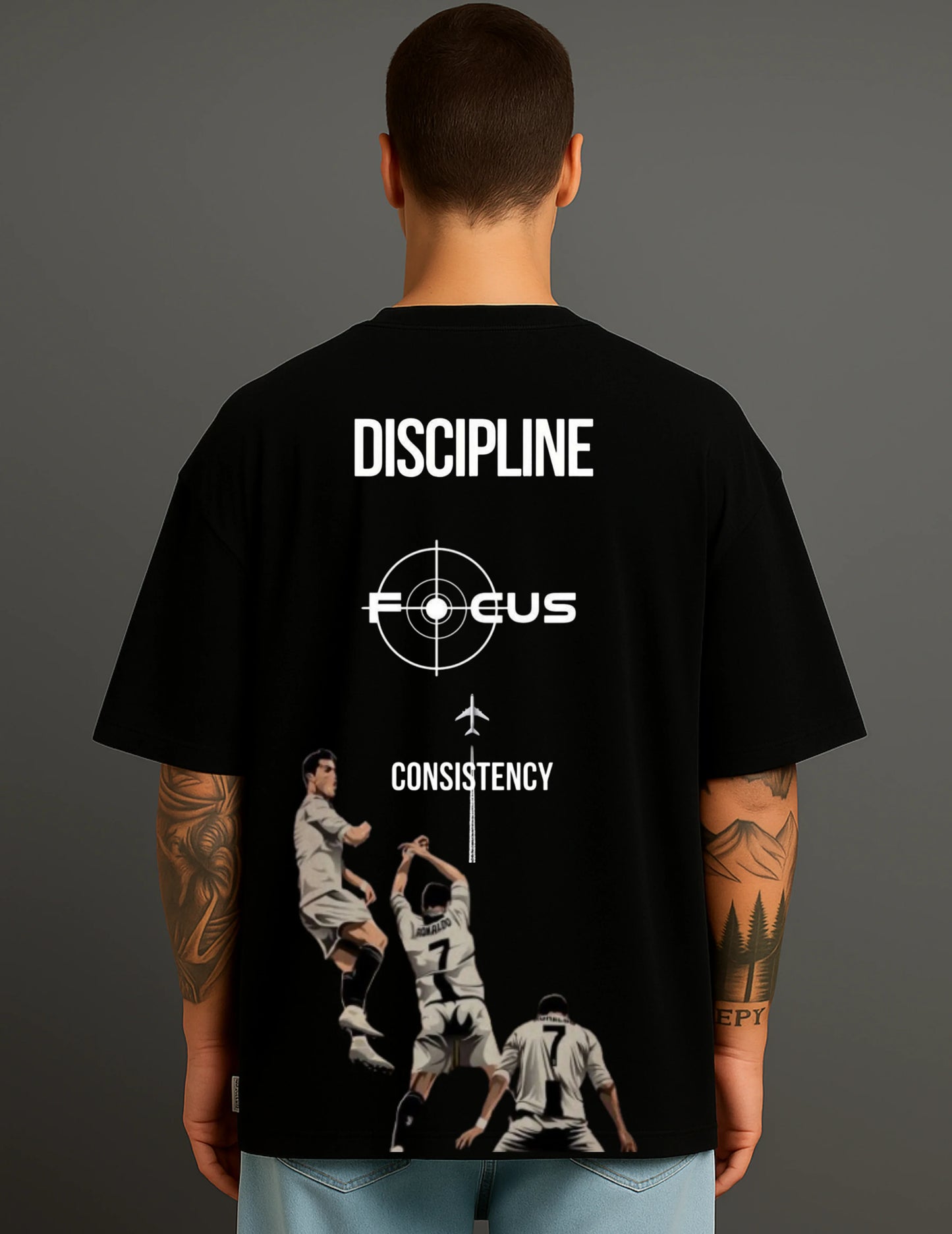 Man wearing ATRAYE black streetwear T-shirt with discipline, focus, and football player print.