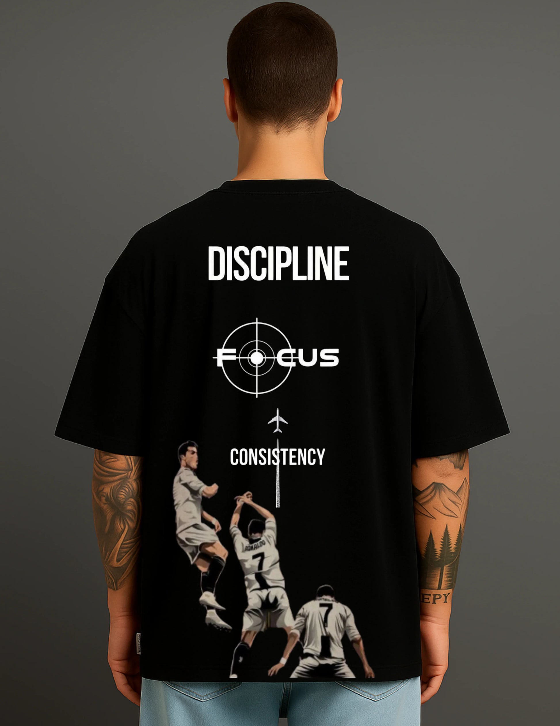 Man wearing ATRAYE black streetwear T-shirt with discipline, focus, and football player print.