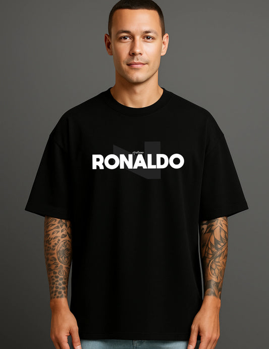 Man wearing a black ATRAYE streetwear T-shirt with bold 'RONALDO' print, tattooed arms visible.