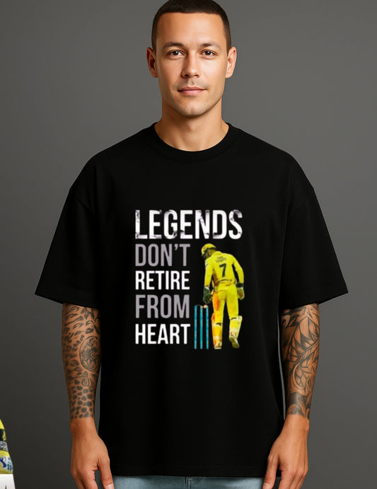 Man wearing black ATRAYE streetwear T-shirt with 'Legends Don't Retire From Heart' cricket graphic
