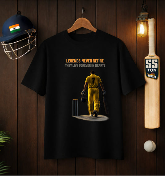 Black ATRAYE streetwear T-shirt featuring cricket legend graphic with 'Legends Never Retire' quote, displayed on wooden wall with helmet and bat decor.
