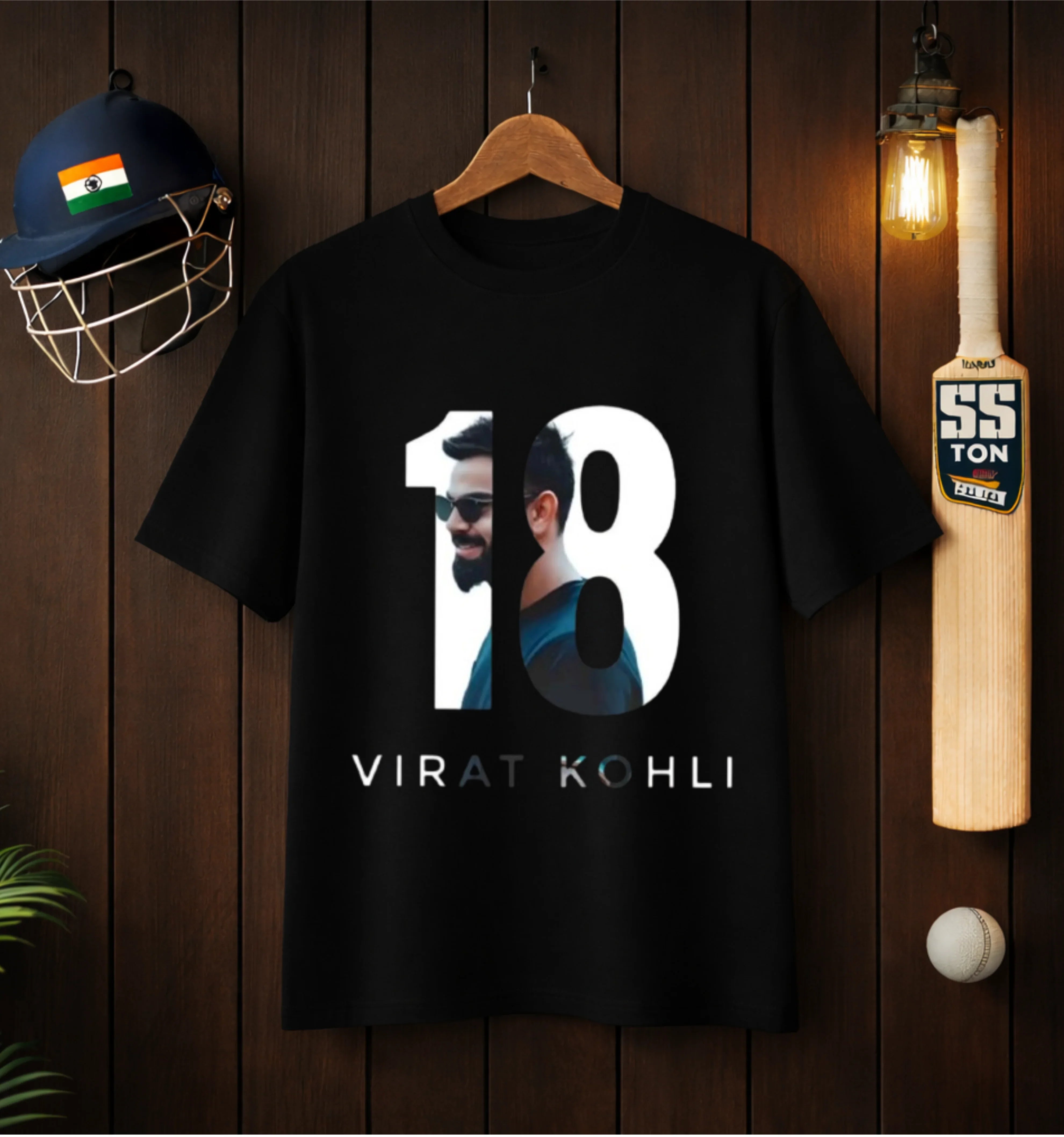 Black streetwear T-shirt featuring number 18 and 'Virat Kohli' print, displayed with cricket helmet and bat.